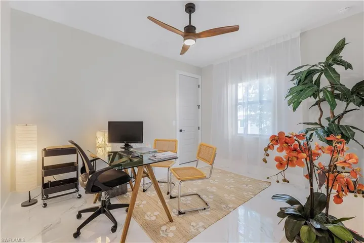Office area featuring ceiling fan and tile patterned flooring