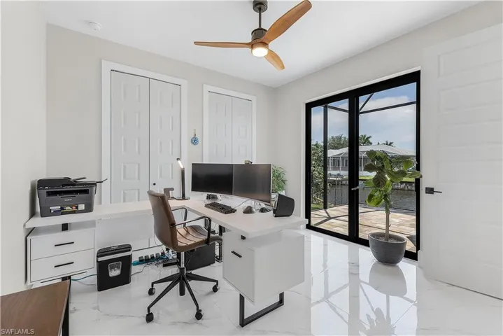 Office space featuring ceiling fan and light tile patterned floors