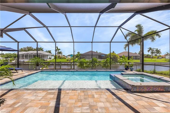View of pool with a lanai, an in ground hot tub, and a patio area