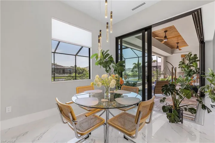 Dining area featuring ceiling fan, a wealth of natural light, and light tile patterned floors