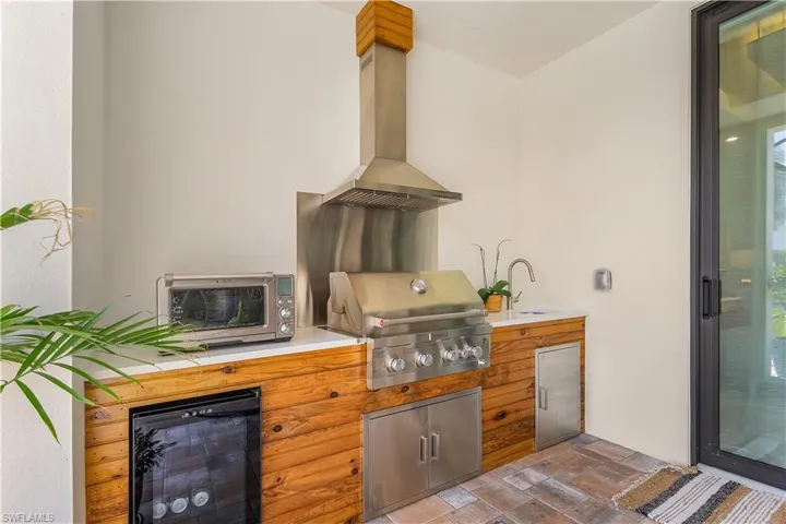 View of patio / terrace with sink, a grill, and exterior kitchen
