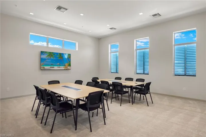 Dining space with light carpet, visible vents, and baseboards