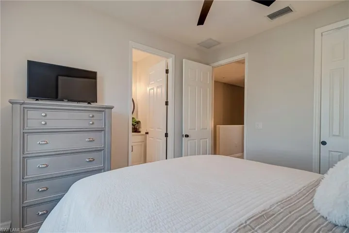 Bedroom with ceiling fan and ensuite bath