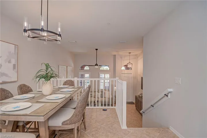 Dining room with a chandelier and light tile patterned floors
