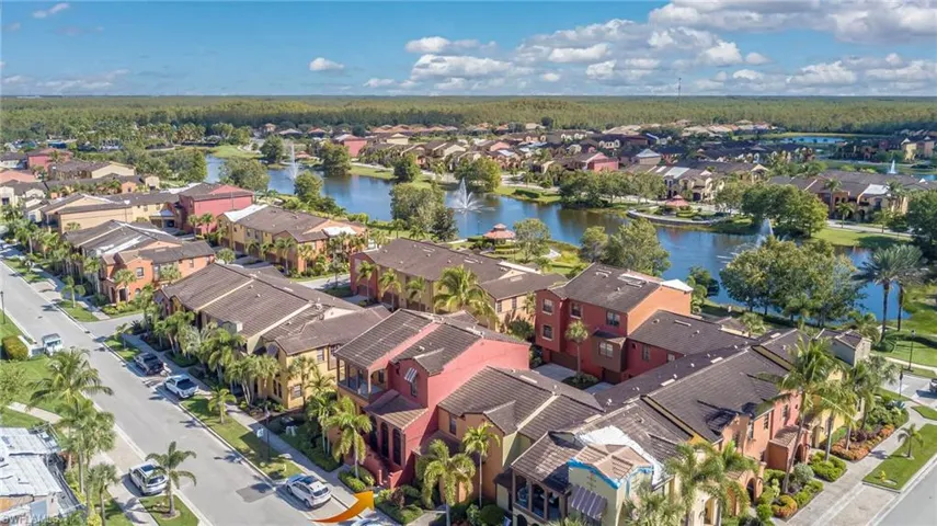 Aerial perspective of suburban area featuring a nearby body of water