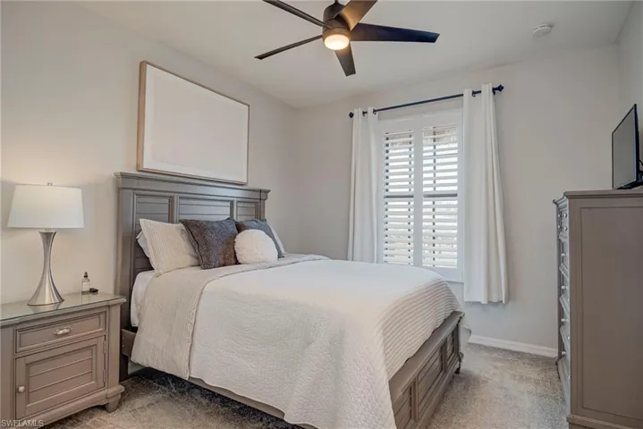 Bedroom featuring ceiling fan and light colored carpet