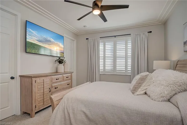 Bedroom featuring light carpet and a ceiling fan