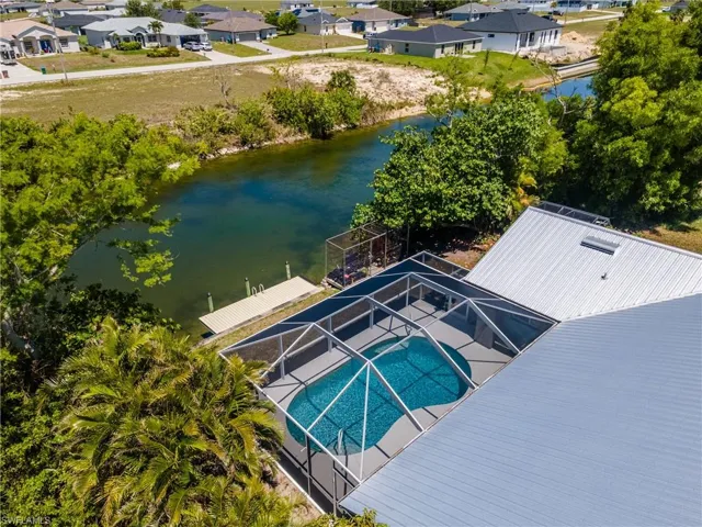 Aerial perspective of suburban area with a nearby body of water