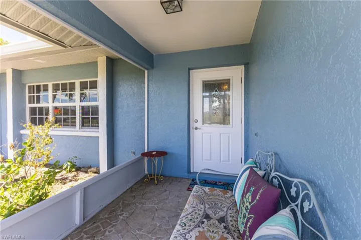 Doorway to property with stucco siding