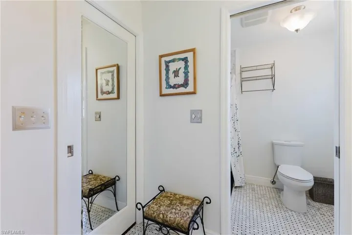 Bathroom featuring toilet, tile patterned floors, and baseboards