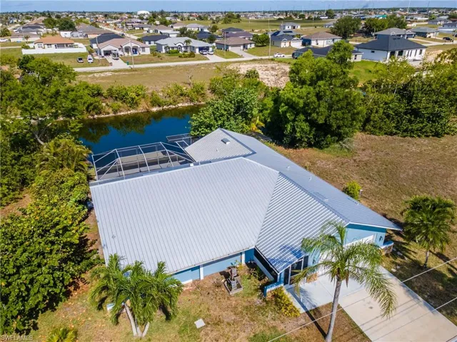 Aerial view of residential area featuring a nearby body of water