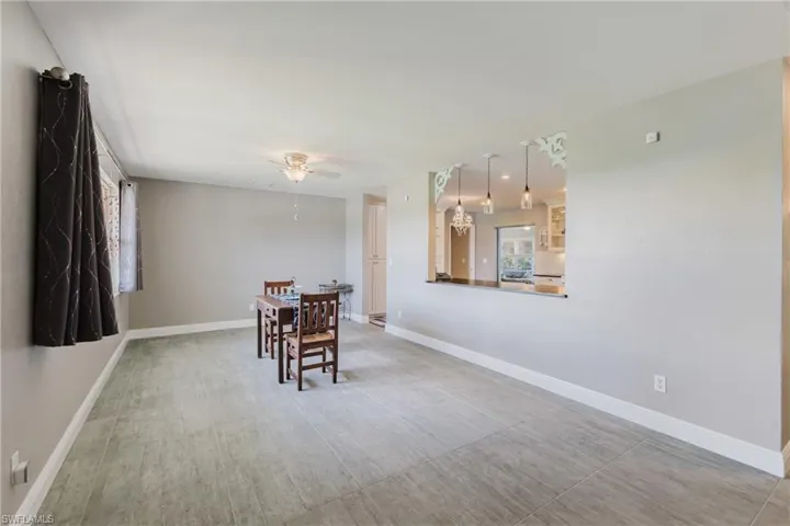 Dining room with ceiling fan and baseboards