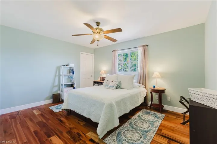 Bedroom with baseboards, a ceiling fan, and wood finished floors