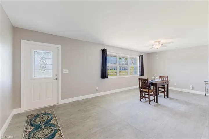 Dining area featuring ceiling fan and baseboards