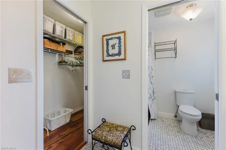 Full bathroom featuring toilet, tile patterned floors, baseboards, and curtained shower