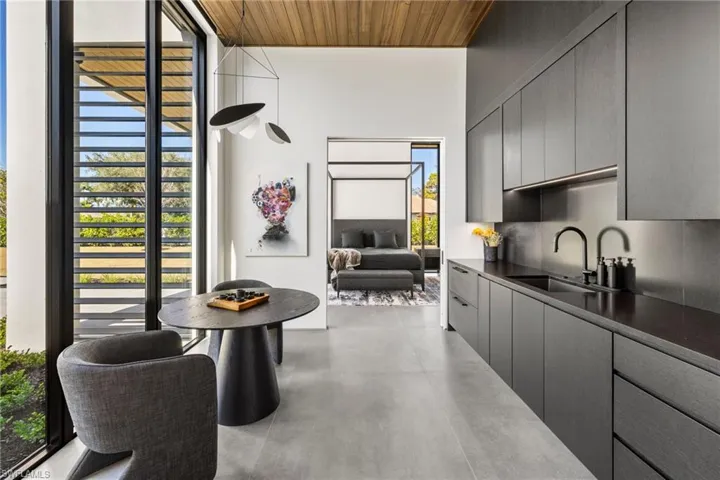 Kitchen featuring gray cabinetry, wood ceiling, and sink