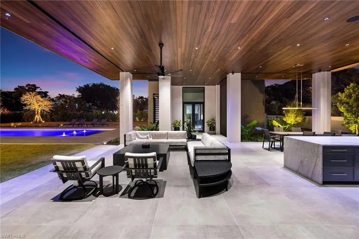 Patio terrace at dusk featuring outdoor lounge area and ceiling fan