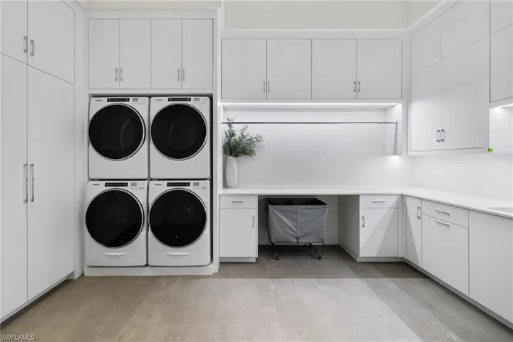 Clothes washing area with cabinets, washer and clothes dryer, and stacked washer / dryer