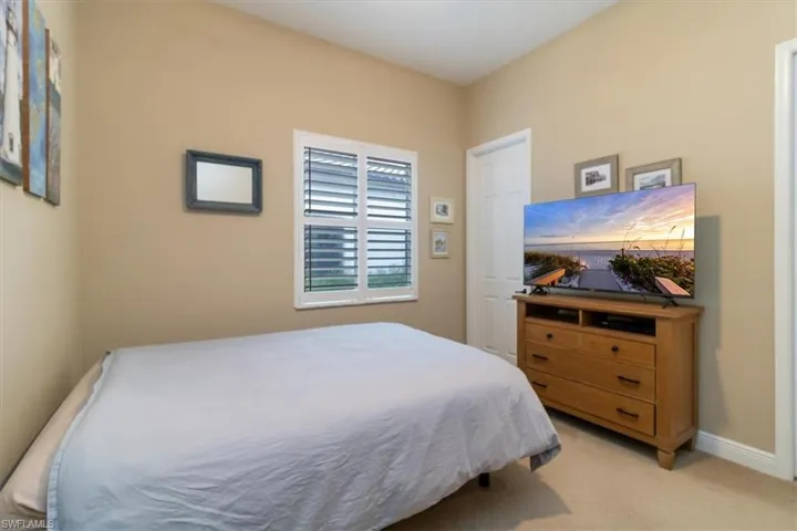 Bedroom featuring light colored carpet