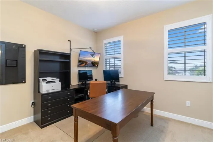 Home office with light colored carpet