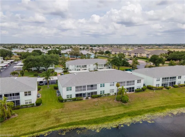 Expansive community featuring multiple two-story buildings with light exteriors and screened lanais