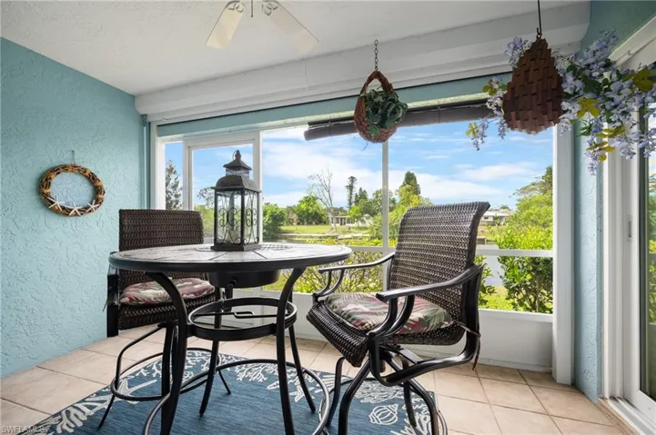 Screened patio featuring tile flooring and textured blue walls