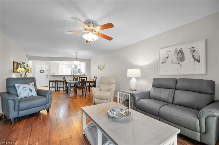 Open-concept living area with wood-finish flooring