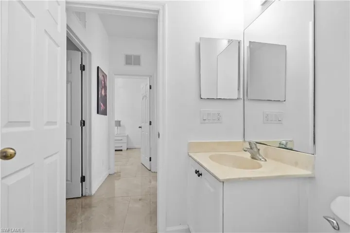 Half bathroom with vanity and toilet
