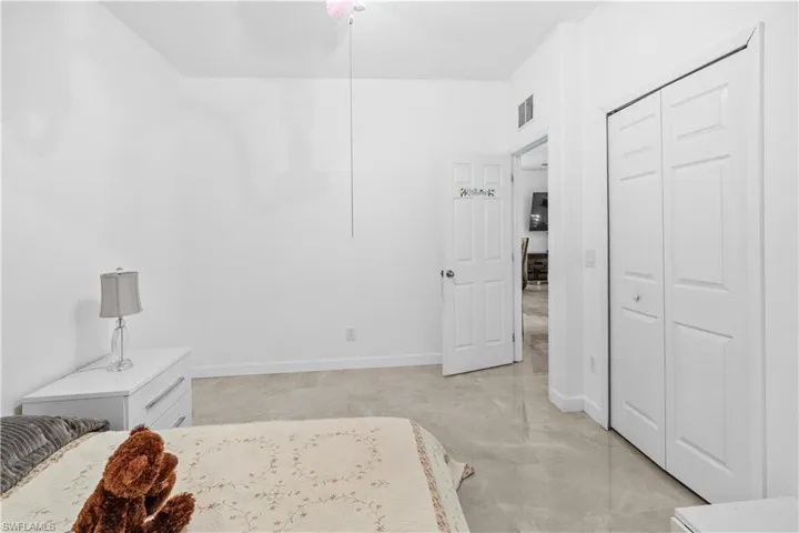 Bedroom featuring baseboards and a closet