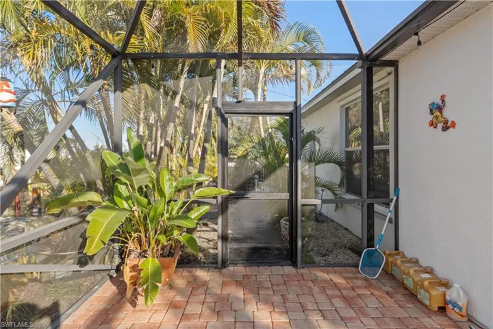 Unfurnished sunroom with a patio area