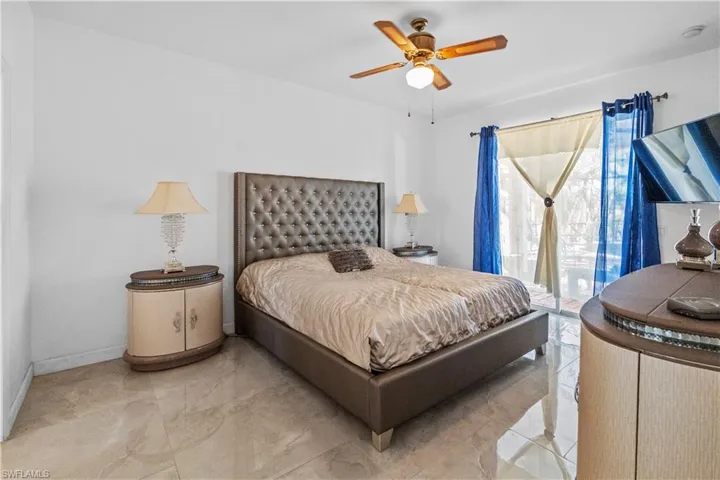 Bedroom with access to outside and ceiling fan