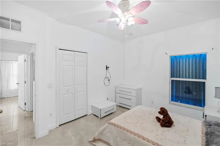 Bedroom featuring a ceiling fan and a closet