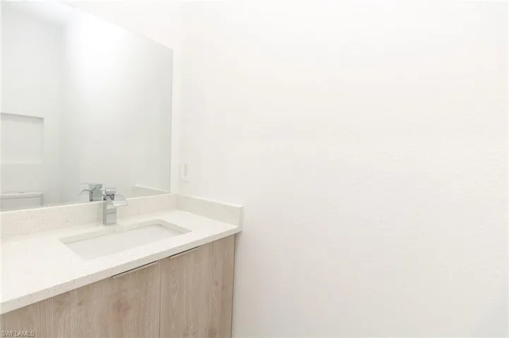 Half bath featuring toilet and vanity