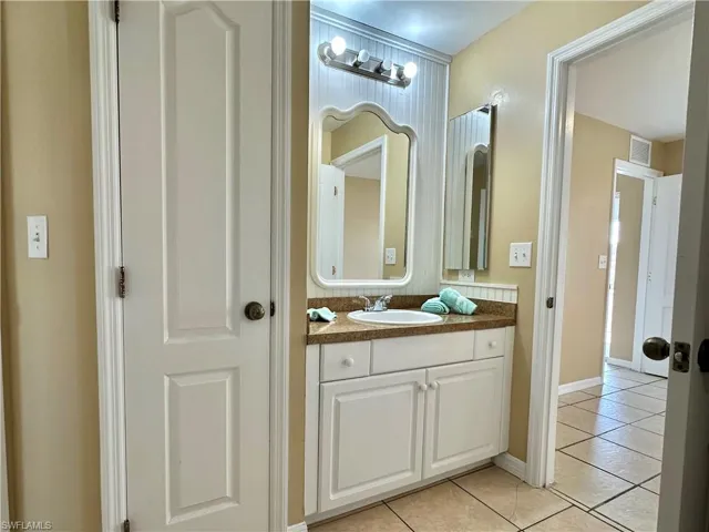 Second Jack 'n Jill Bath with Utility Closet, Mirrored Vanity and Paneled Back