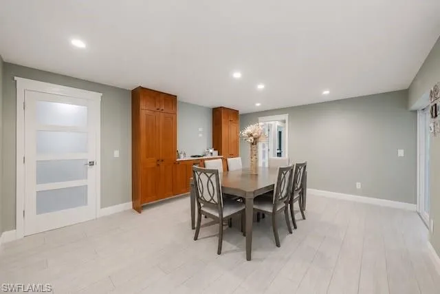 Recessed lighting illuminates wood-finish flooring