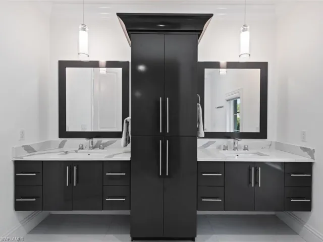 Bathroom featuring vanity, tile patterned floors, and crown molding