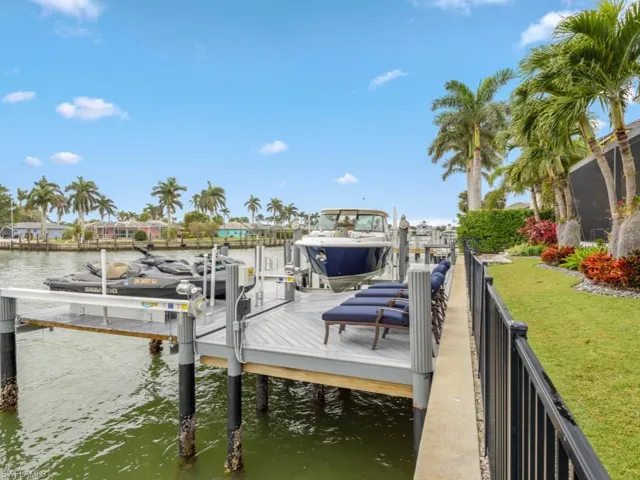 Dock area featuring a lawn and a water view