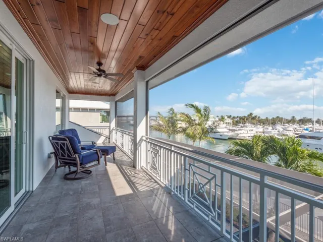 Balcony with ceiling fan and a water view