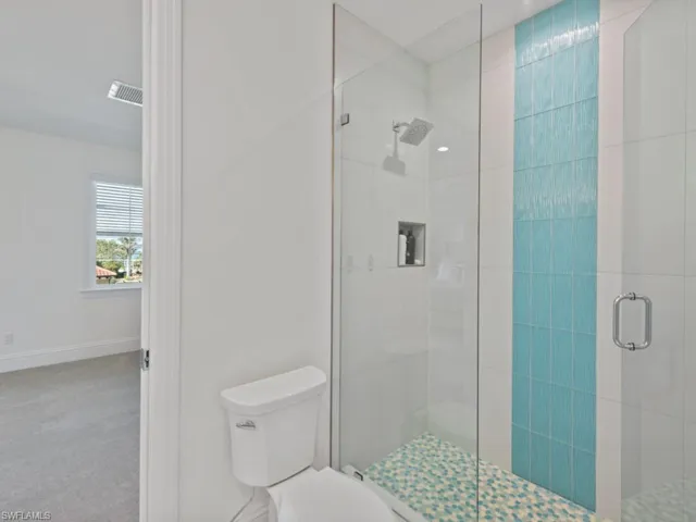 Bathroom with toilet and a shower with door