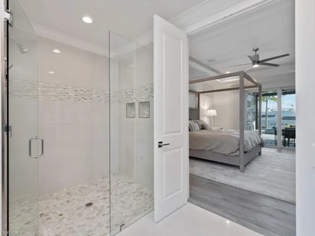 Tiled bedroom featuring ceiling fan, access to outside, and ornamental molding