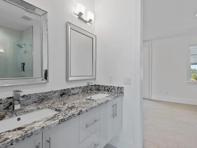 Bathroom featuring an enclosed shower and vanity