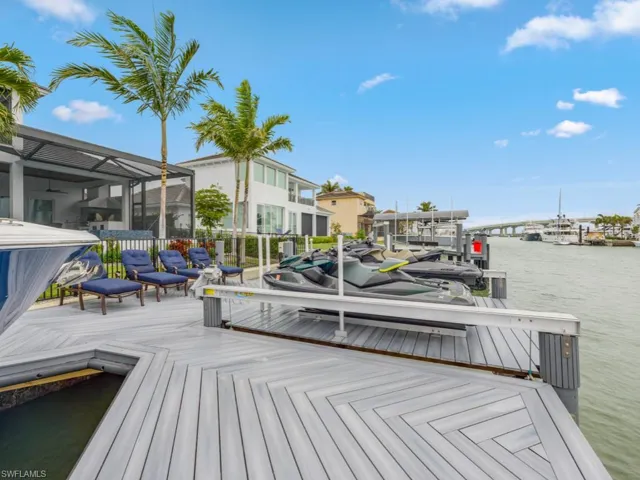 Dock area with a lanai and a water view