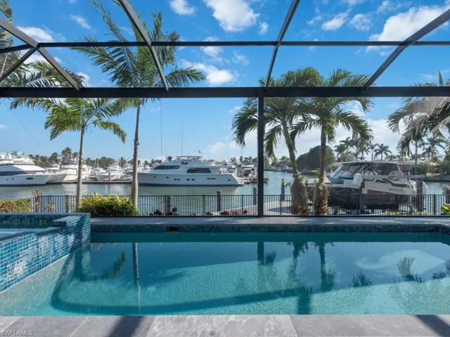 View of pool featuring a lanai and a water view