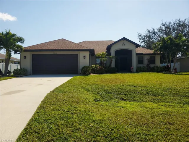 Front of home with nice yard and long drive