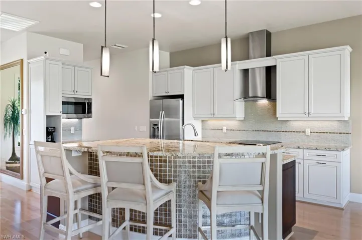 View of breakfast bar and island kitchen