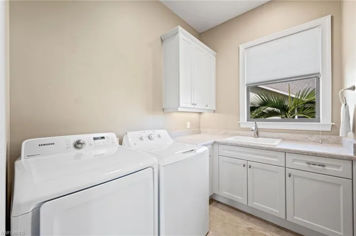 Inside laundry room with window, built-in sink and folding area