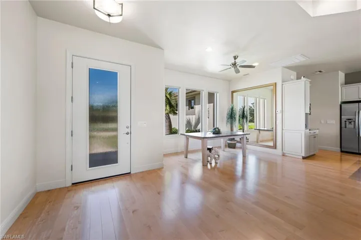 Inside of front entry and formal dining area with gleaming hardwood floors