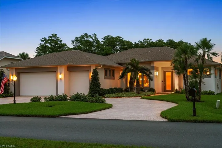 wilight view of front of home with Paver Brick Circle Drive and 3 Car Garage.