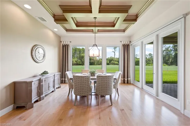 Informal dining area with custom coffered tray ceiling and French doors to lanai.