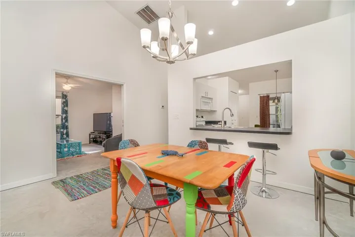 Dining area with vaulted ceiling and breakfast bar